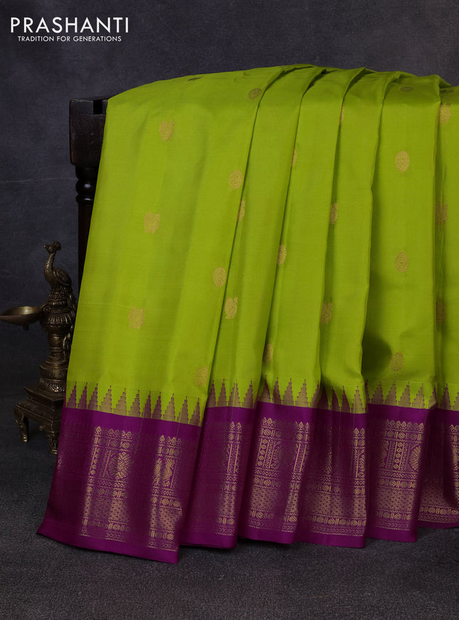 Pure gadwal silk saree light green and dark pink with allover zari woven buttas and temple design zari woven border