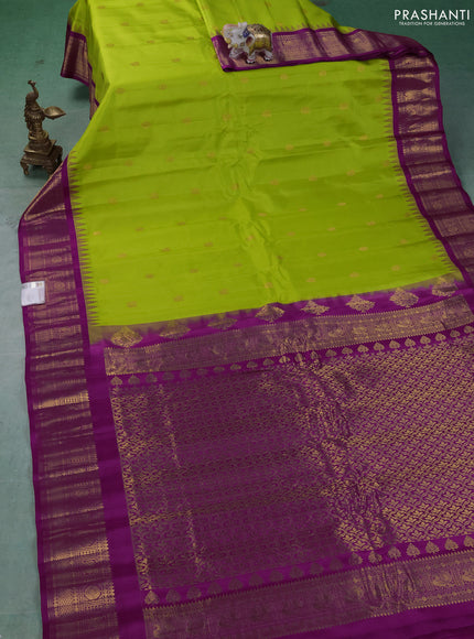 Pure gadwal silk saree light green and dark pink with allover zari woven buttas and temple design zari woven border