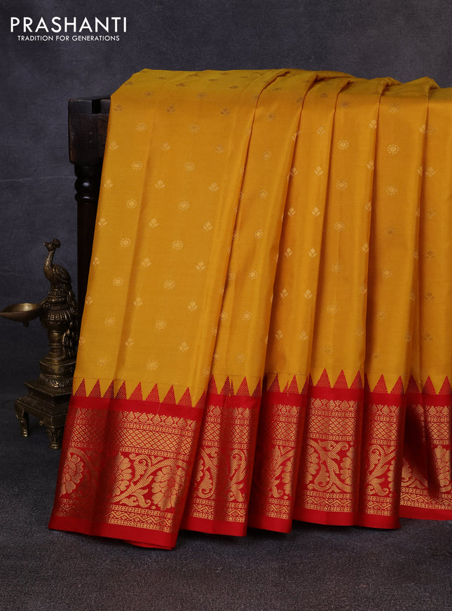 Pure gadwal silk saree mustard yellow and red with allover zari woven buttas and temple design zari woven border