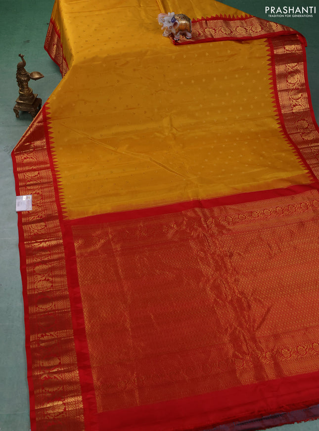 Pure gadwal silk saree mustard yellow and red with allover zari woven buttas and temple design zari woven border
