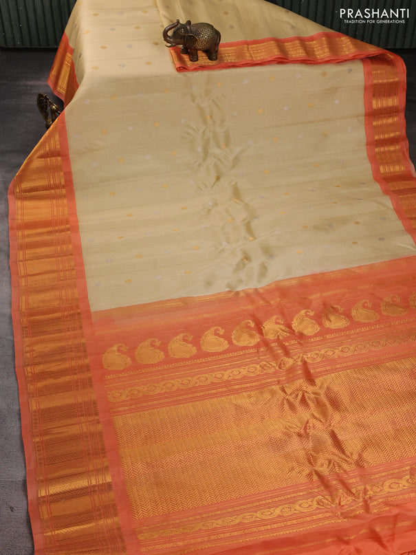 Pure gadwal silk saree cream and peach orange with allover silver & zari woven buttas and zari woven korvai border