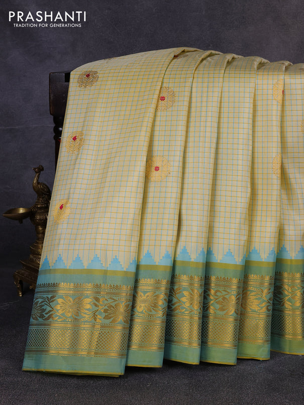 Pure gadwal silk saree cream and pista green with allover checks & zari woven buttas and temple design zari woven border