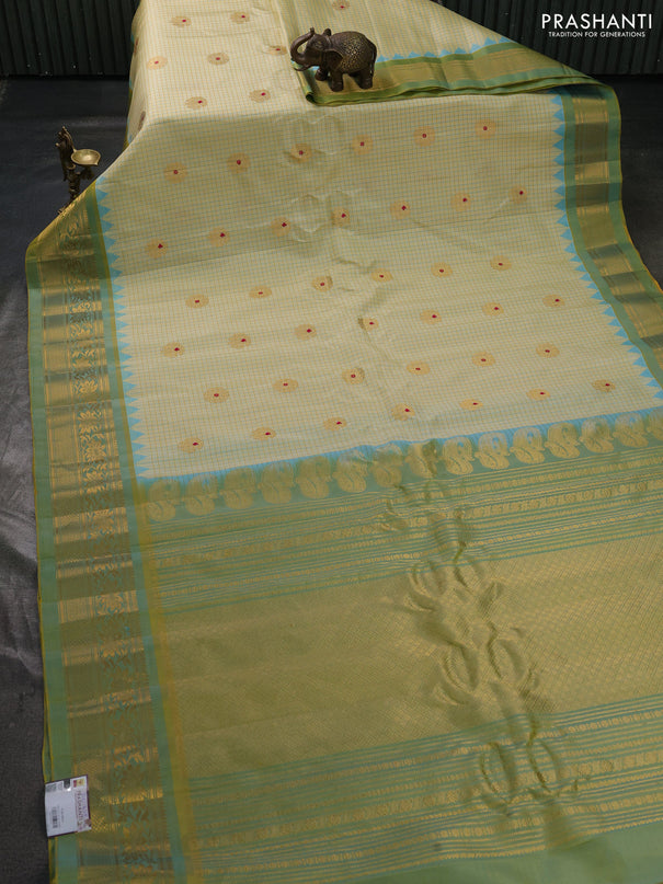 Pure gadwal silk saree cream and pista green with allover checks & zari woven buttas and temple design zari woven border