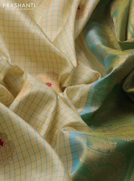 Pure gadwal silk saree cream and pista green with allover checks & zari woven buttas and temple design zari woven border