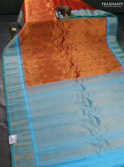 Pure gadwal tissue silk saree rust shade and teal blue with allover thread woven buttas and temple design zari woven border