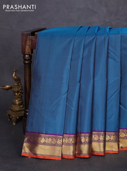 Pure kanchipuram silk saree peacock green and purple with plain body and zari woven border