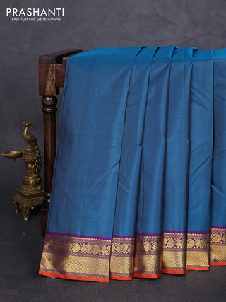 Pure kanchipuram silk saree peacock green and purple with plain body and zari woven border