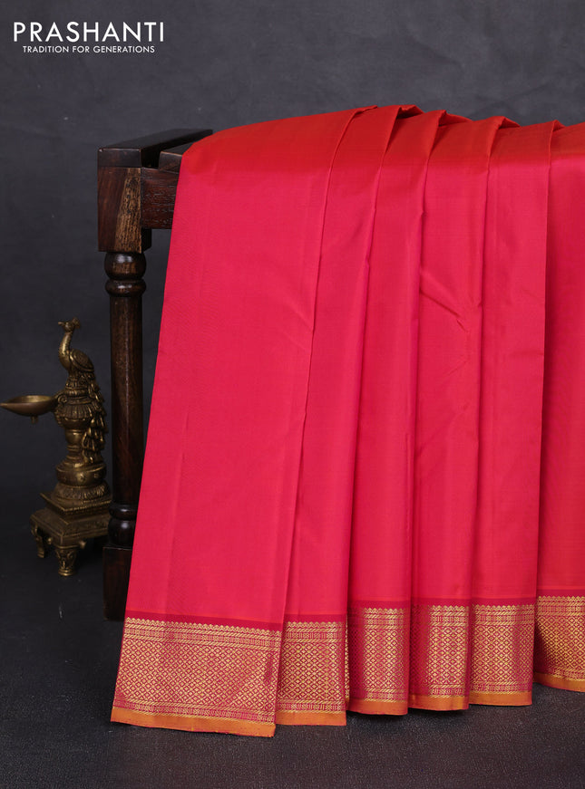 Pure kanchipuram silk saree dual shade of pinkish orange and mustard yellow with plain body and temple zari woven border