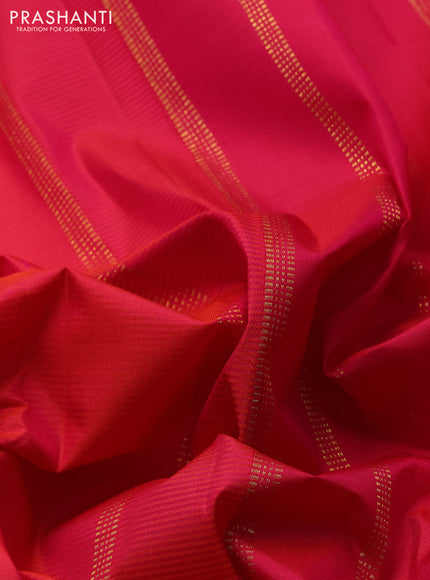 Pure kanchipuram silk saree dual shade of pinkish orange and mustard yellow with plain body and temple zari woven border