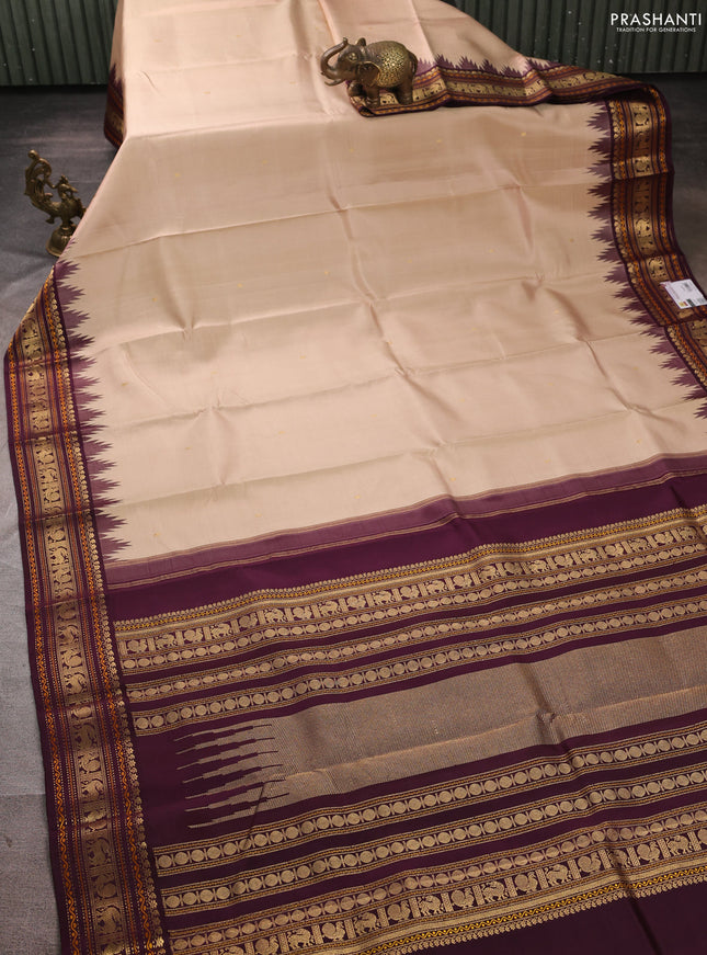 Pure kanchipuram silk saree beige and deep wine with zari woven buttas and temple design zari woven border