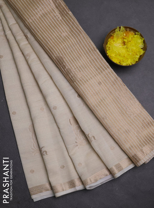 Semi raw silk saree cream with zari woven buttas and small zari woven border