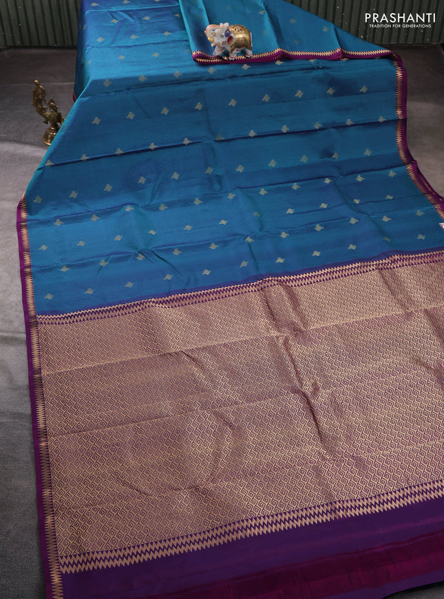 Pure kanchipuram silk saree peacock blue and purple with allover self emboss zari buttas and small zari woven border