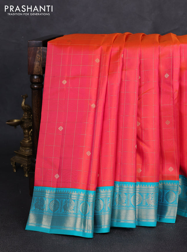 Pure kanchipuram silk saree dual shade of pinkish orange and teal blue with allover zari checks & buttas and zari woven korvai border