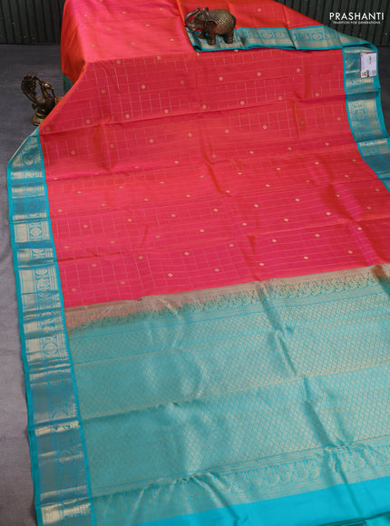 Pure kanchipuram silk saree dual shade of pinkish orange and teal blue with allover zari checks & buttas and zari woven korvai border
