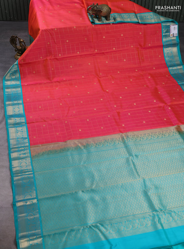 Pure kanchipuram silk saree dual shade of pinkish orange and teal blue with allover zari checks & buttas and zari woven korvai border