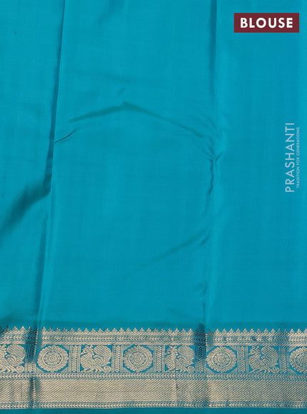 Pure kanchipuram silk saree dual shade of pinkish orange and teal blue with allover zari checks & buttas and zari woven korvai border