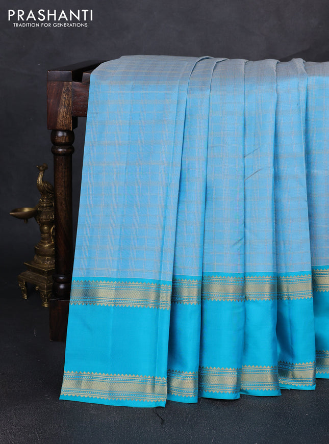 Pure kanchipuram silk saree pastel blue and teal blue with allover zari checked pattern and rettapet zari woven border