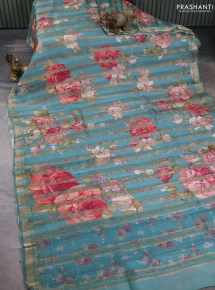 Organza tissue tussar silk saree teal blue with allover zari stripe pattern & floral prints and zari woven border