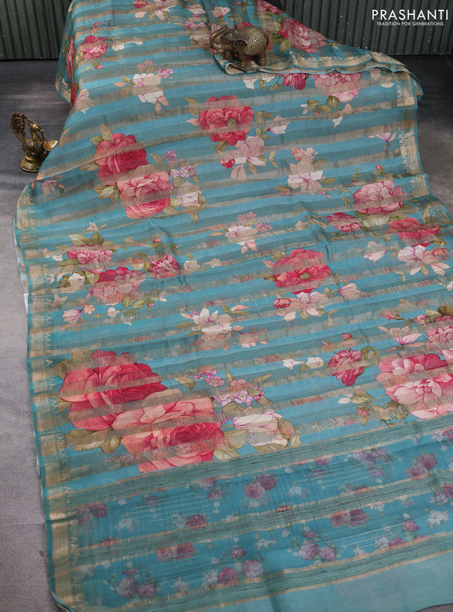 Organza tissue tussar silk saree teal blue with allover zari stripe pattern & floral prints and zari woven border