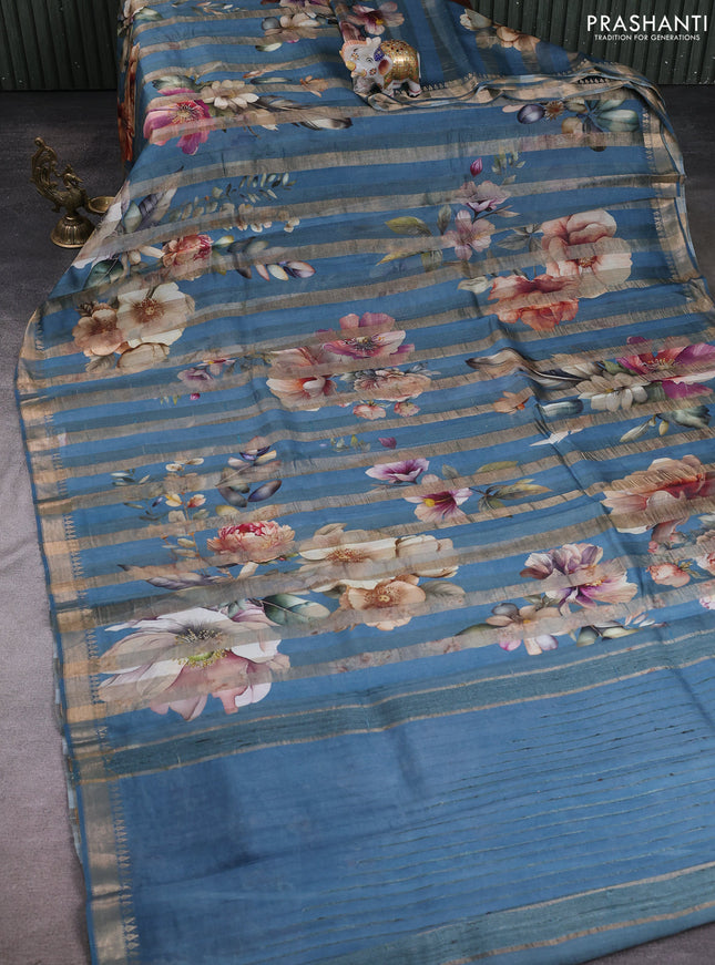 Organza tissue tussar silk saree cs blue with allover zari stripe pattern & floral prints and zari woven border