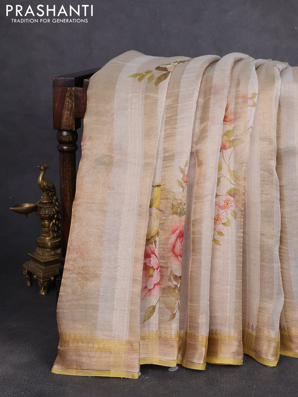 Organza tissue tussar silk saree cream shade with allover zari stripe pattern & floral prints and zari woven border