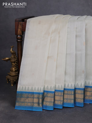 Silk cotton saree off white and cs blue with zari woven buttas and temple design zari woven korvai border