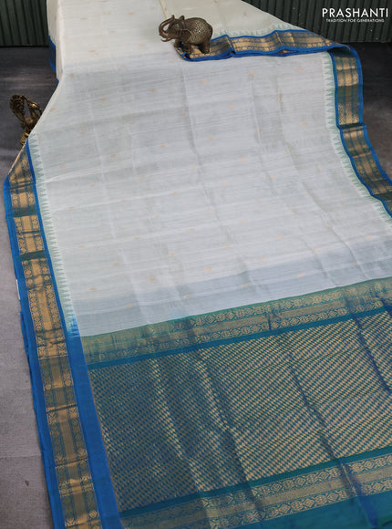 Silk cotton saree off white and cs blue with zari woven buttas and temple design zari woven korvai border