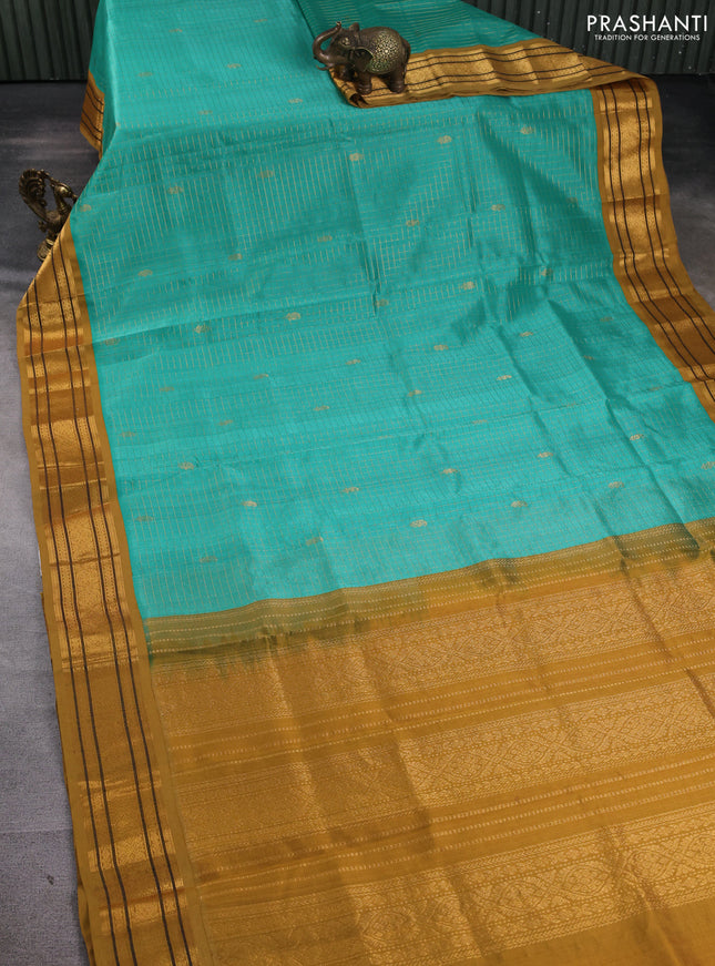 Silk cotton saree teal blue and dark ustard with allover zari checks & buttas and zari woven korvai border