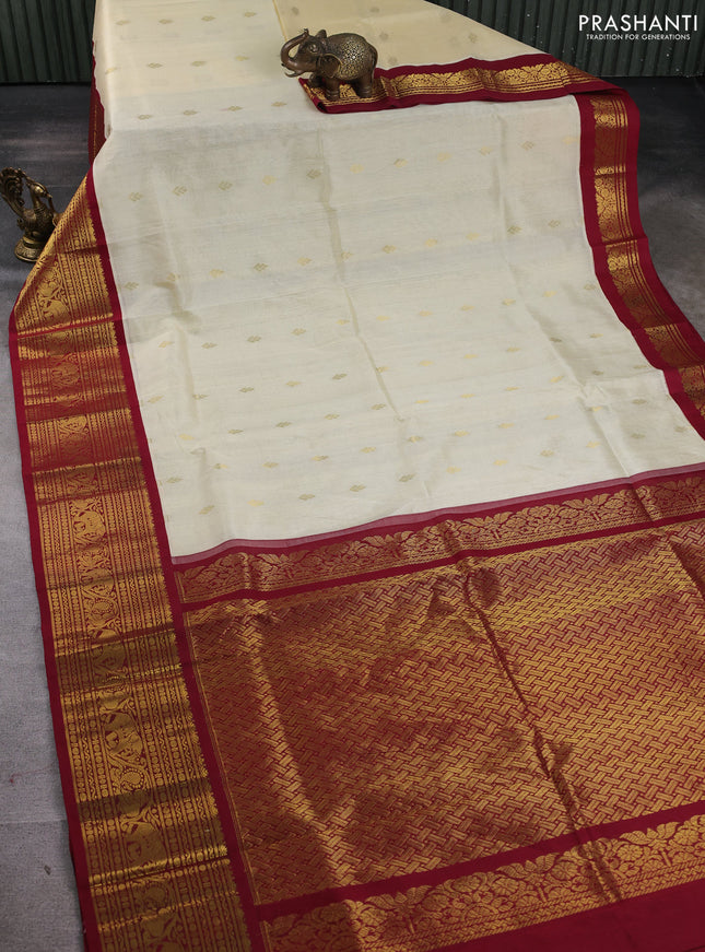 Silk cotton saree cream and maroon with zari woven buttas and long zari woven korvai border