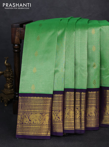 Silk cotton saree light green and deep purple with allover zari woven buttas and long zari woven korvai border