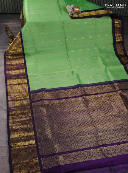 Silk cotton saree light green and deep purple with allover zari woven buttas and long zari woven korvai border