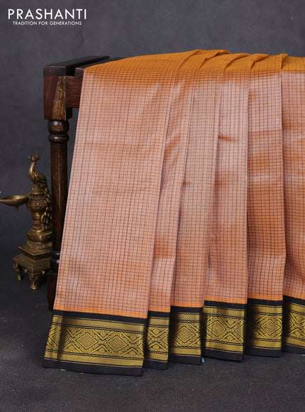 Silk cotton saree pale orange and black with allover checked pattern and zari woven korvai border