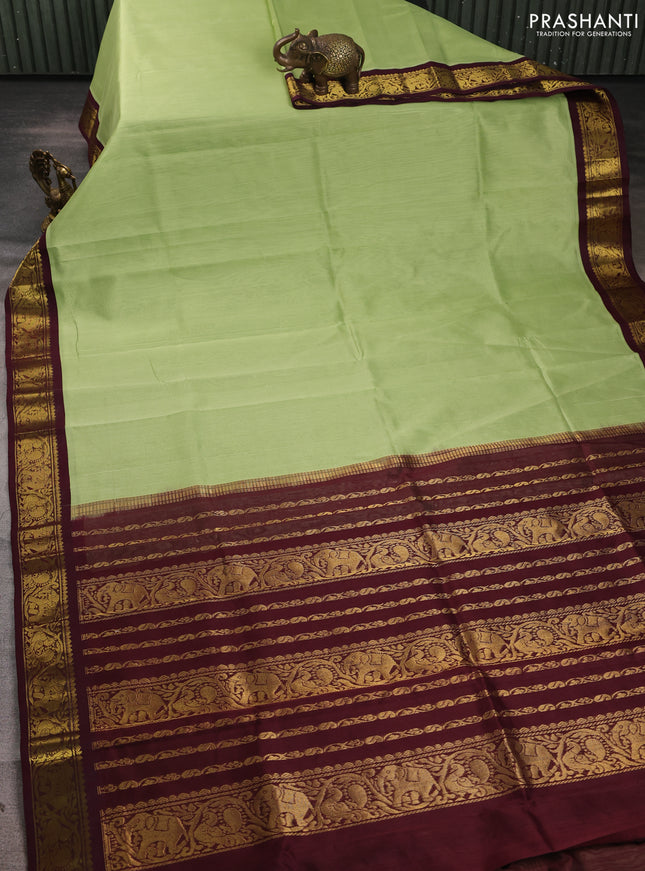 Silk cotton saree pista green and deep maroon with plain body and zari woven border