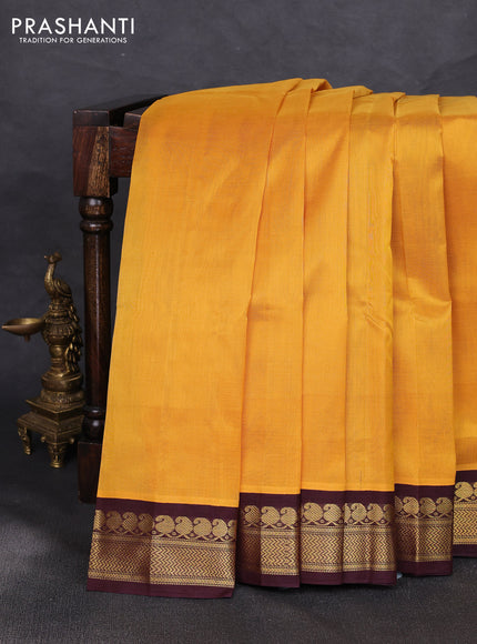 Silk cotton saree yellow and coffee brown with plain body and zari woven korvai border