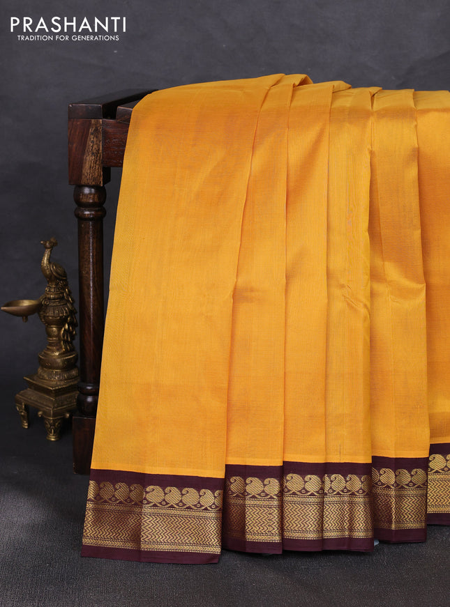Silk cotton saree yellow and coffee brown with plain body and zari woven korvai border