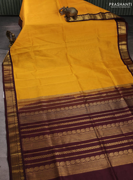 Silk cotton saree yellow and coffee brown with plain body and zari woven korvai border