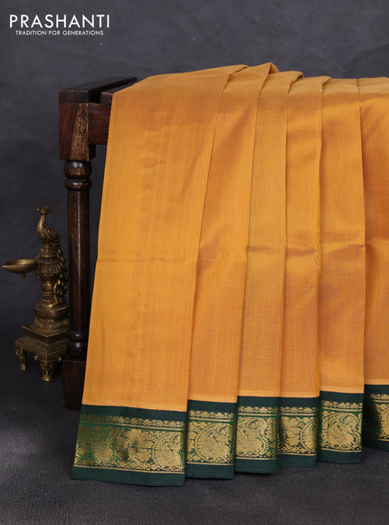 Silk cotton saree sandal and bottle green with plain body and zari woven korvai border