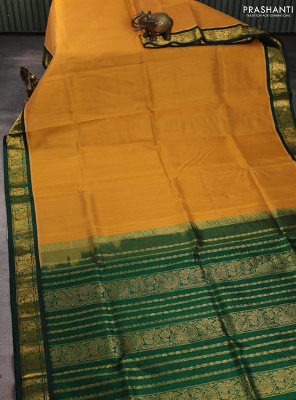 Silk cotton saree sandal and bottle green with plain body and zari woven korvai border