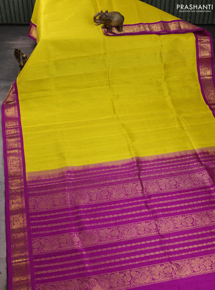 Silk cotton saree yellow and purple with plain body and zari woven korvai border