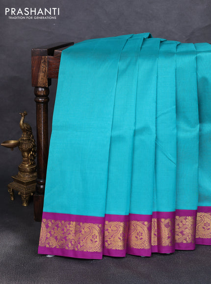 Silk cotton saree teal blue and purple with plain body and zari woven korvai border