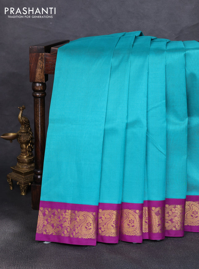Silk cotton saree teal blue and purple with plain body and zari woven korvai border