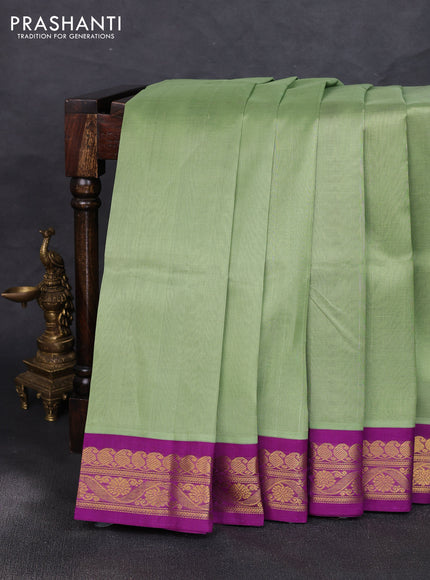 Silk cotton saree pista green and purple with plain body and zari woven korvai border