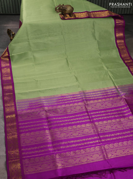Silk cotton saree pista green and purple with plain body and zari woven korvai border
