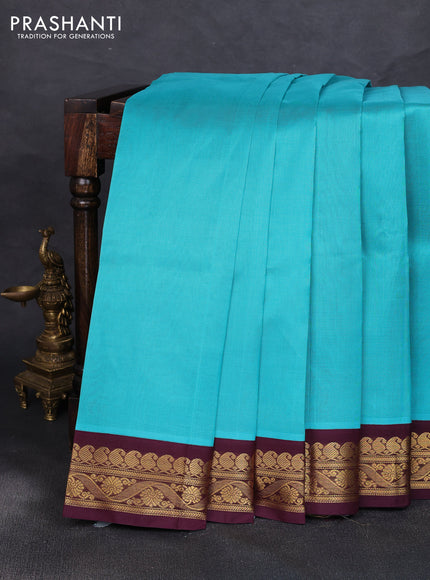 Silk cotton saree teal blue and deep maroon with plain body and zari woven korvai border