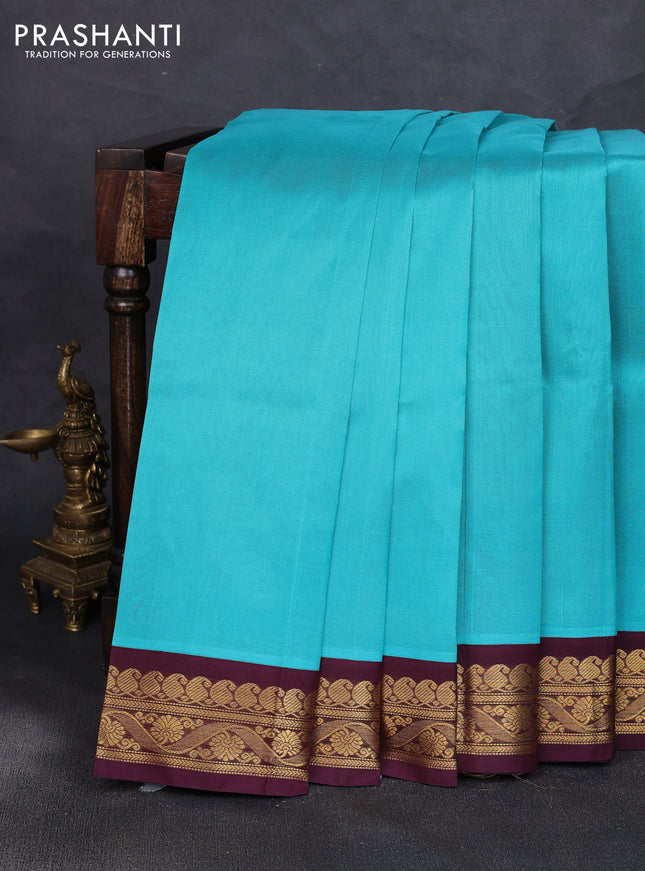 Silk cotton saree teal blue and deep maroon with plain body and zari woven korvai border