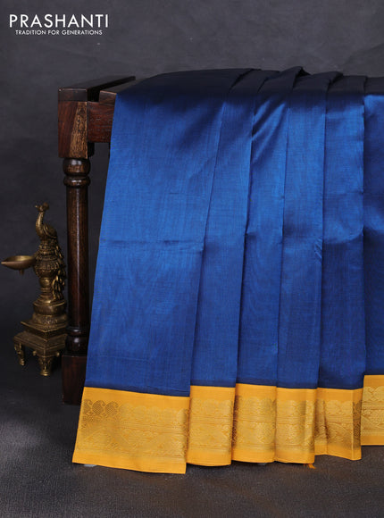 Silk cotton saree peacock blue and yellow with plain body and zari woven korvai border