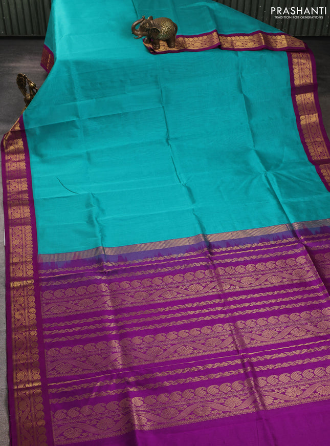 Silk cotton saree teal blue and purple with plain body and zari woven korvai border