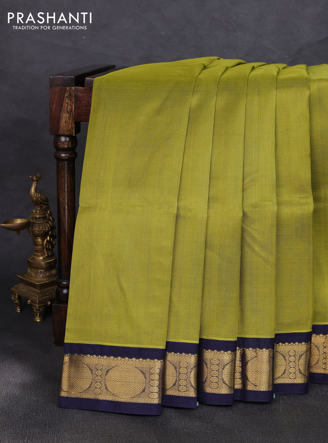 Silk cotton saree mehendi green and navy blue with plain body and rudraksha zari woven korvai border