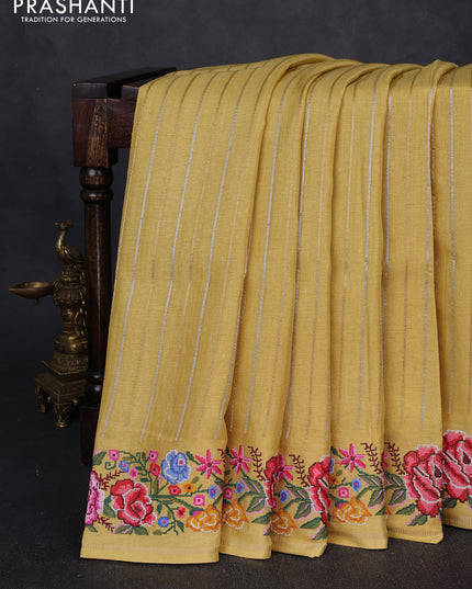 Semi tussar saree yellow with allover zari stripe pattern and floral embroidery border