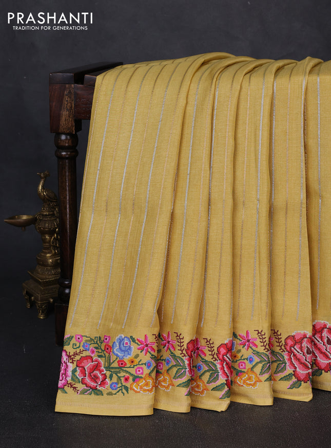 Semi tussar saree yellow with allover zari stripe pattern and floral embroidery border
